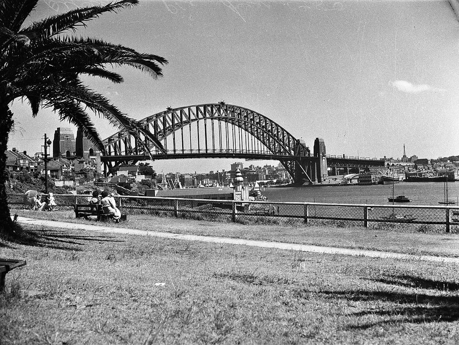 Sydney Harbour Bridge across the water from a foreshore park — photograph, from Sydney Harbour Bridge, 1950