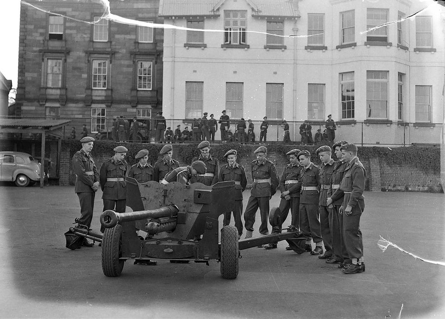 Cadets around a field gun, Sydney Grammar School — photograph, from Sydney Grammar School, 1954