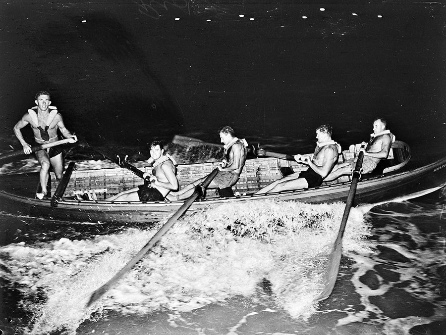 Coogee surf boat crew at the oars, night training — photograph, from Coogee Beach, 1946