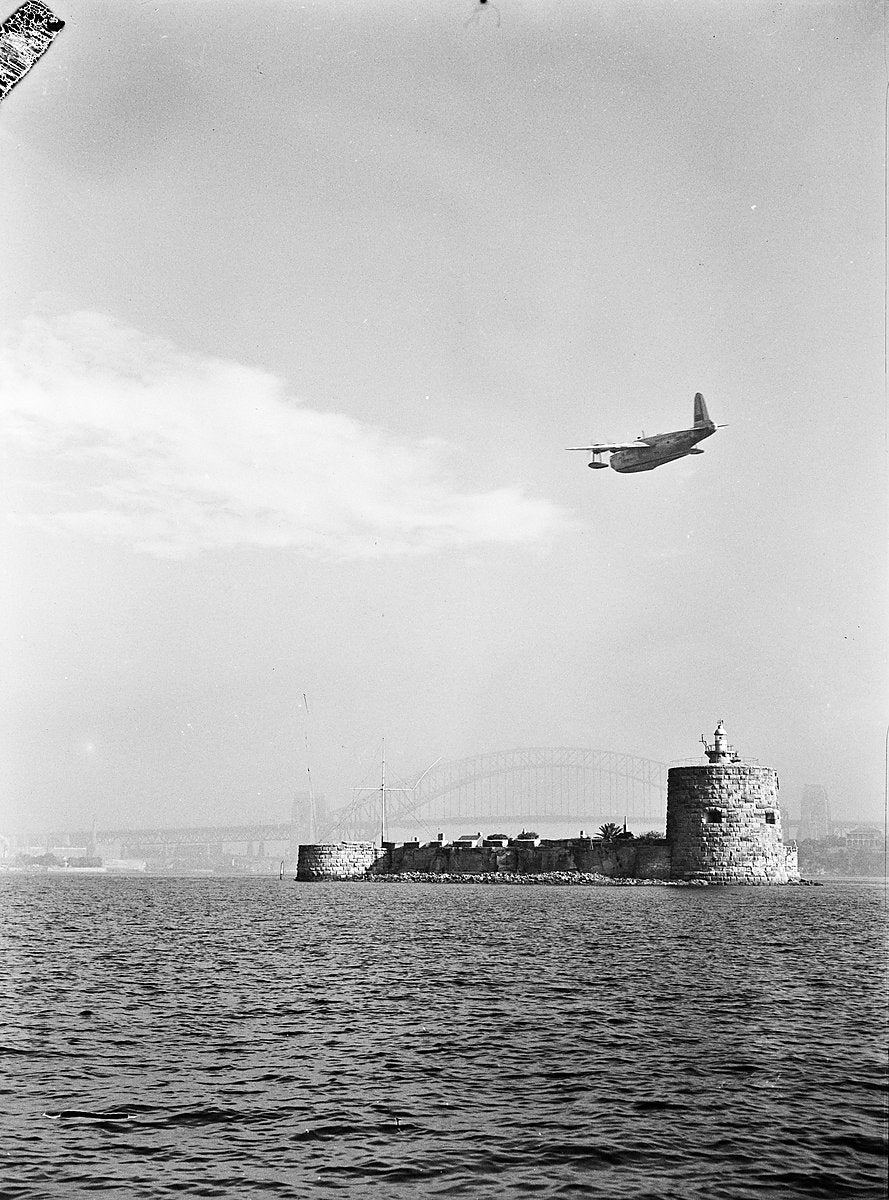 Seaplane passing over Fort Denison, Sydney Harbour — photograph, from Potts Point, c. 1950