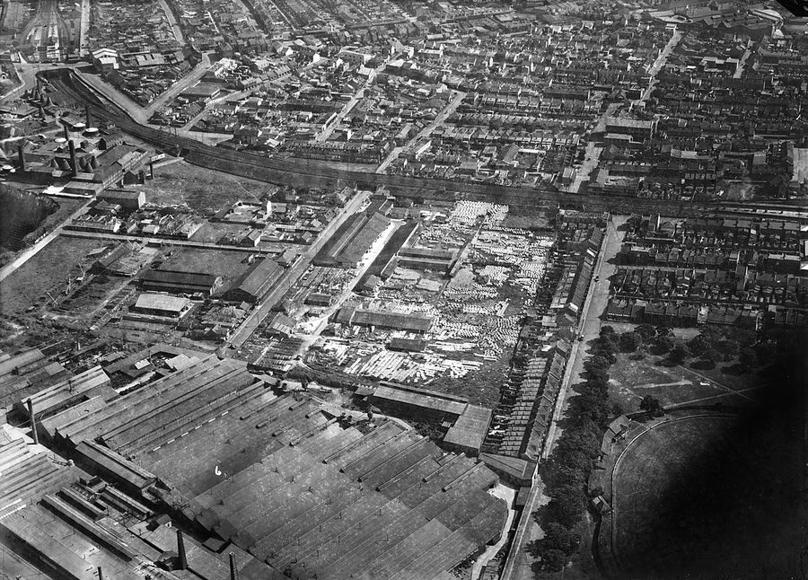 Aerial view over an Alexandria industrial precinct with pipe yards and terraced housing — photograph, from Alexandria, 1930s