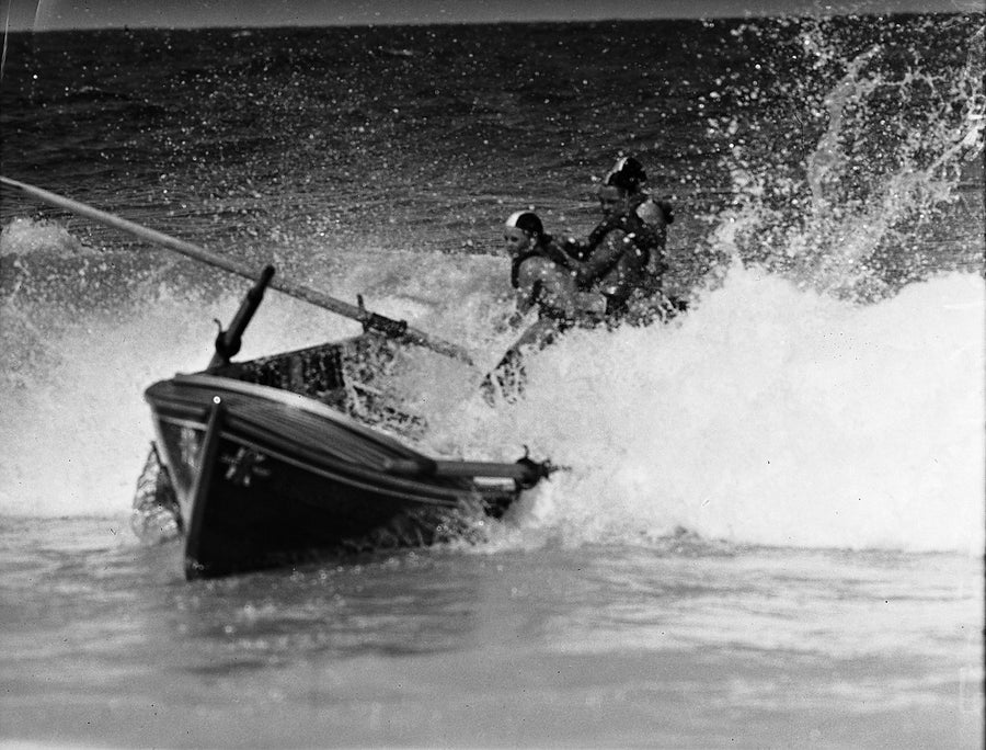 Surf boat crew driving through the break, Coogee — photograph, from Coogee Beach, 1952