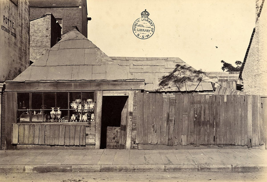 Pottie's shopfront and condemned timber buildings, Castlereagh Street, Sydney — photograph, from Castlereagh Street, c. 1875–85