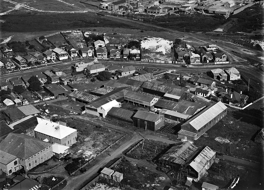 Aerial view over an industrial and residential block, with Norton Bros factory sheds — photograph, 1930s
