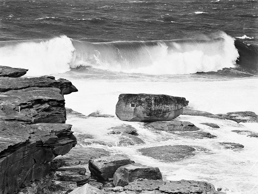 Heavy surf breaking over a sandstone rock platform — photograph, 1940