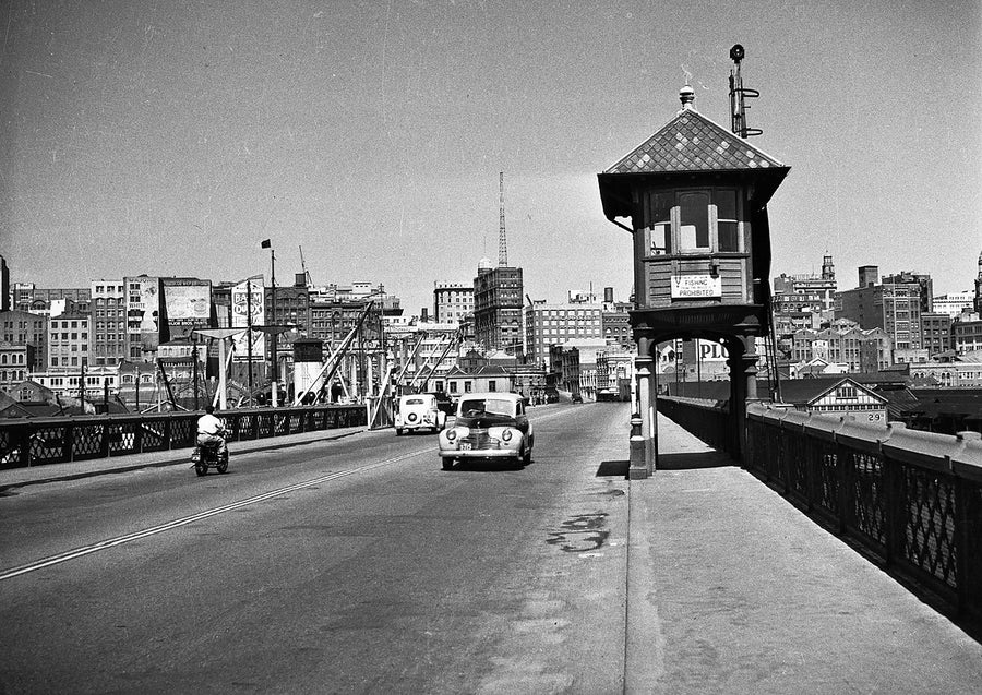 Watch house on Pyrmont Bridge, with the city skyline beyond — photograph, from Pyrmont Bridge, 1950