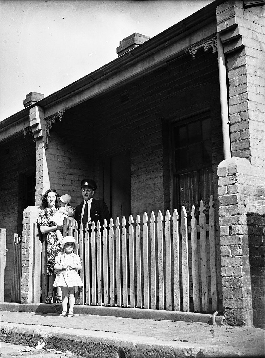 Family at the picket fence of an Erskineville cottage — photograph, from Erskineville, 1938