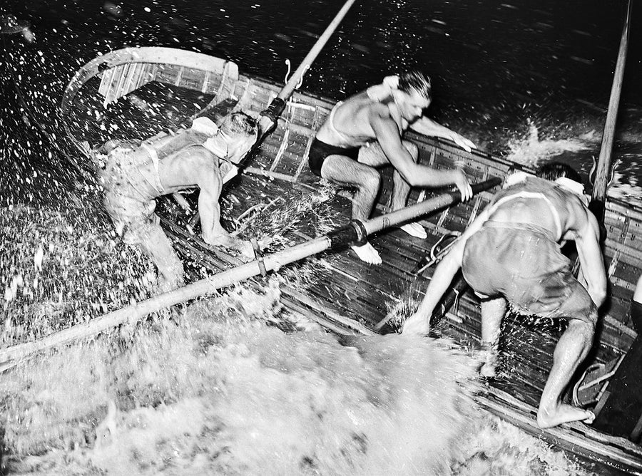 Coogee surf boat crew battling the swell at night — photograph, from Coogee Beach, 1946