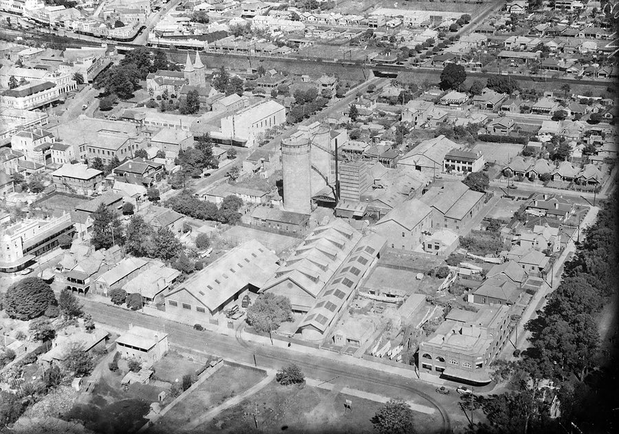 Factory complex, church and channelled waterway from the air — photograph, c. 1939