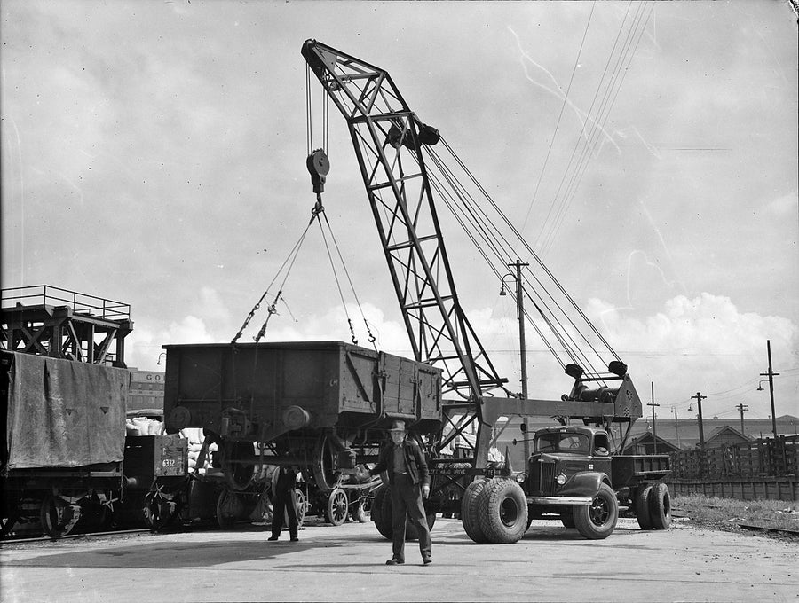 White truck crane lifting a railway goods wagon, Sydney — photograph, from Sydney, c. 1935–54