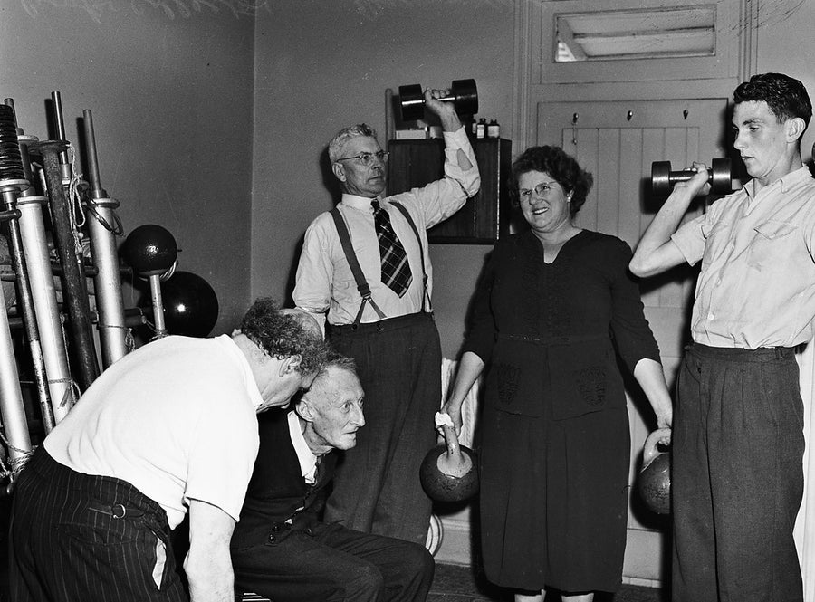 Weight training in a Marrickville room — photograph, from Marrickville, 1949