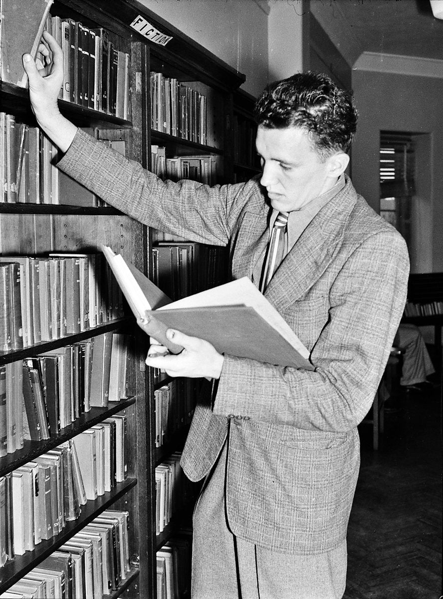 Browsing the fiction shelves at a Sydney teachers college — photograph, 1950