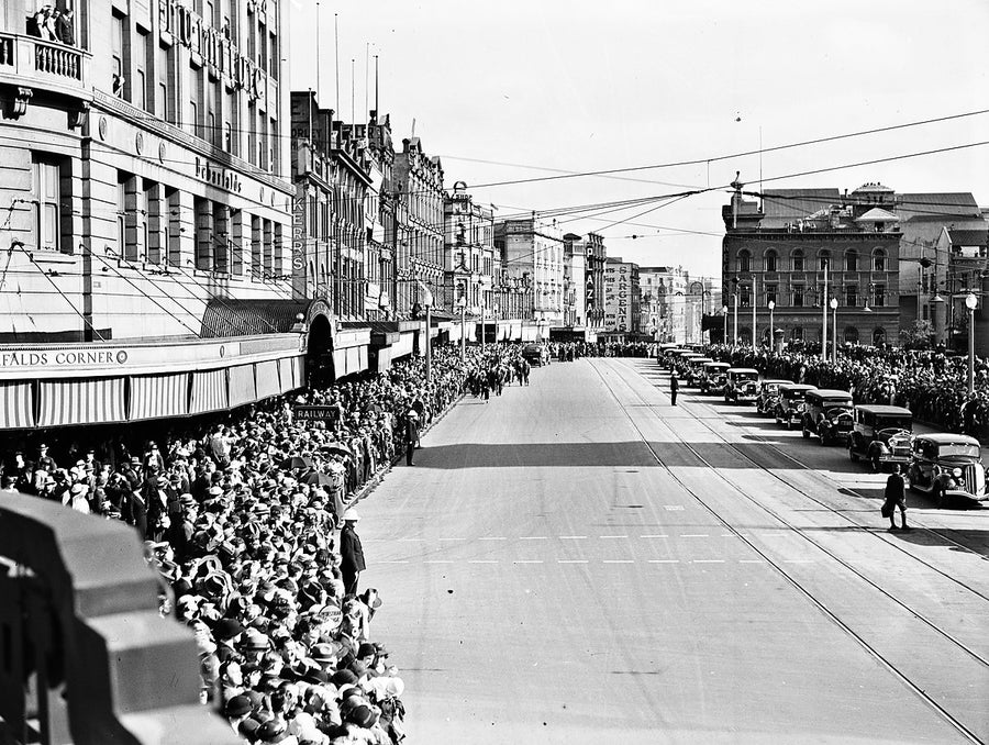 Crowds line George Street at Bebarfald's Corner opposite Sydney Town Hall — photograph, 1935