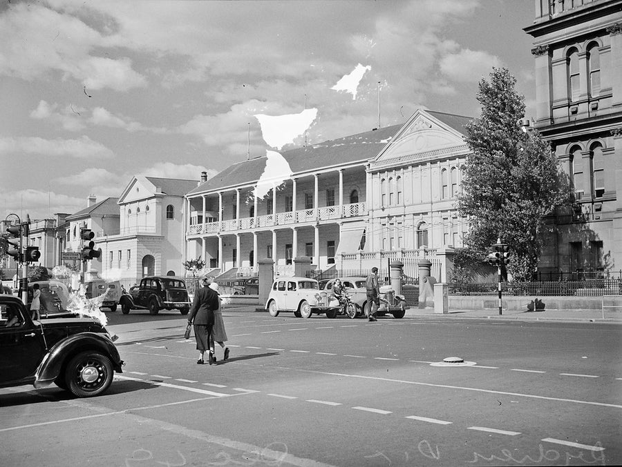Parliament House, Macquarie Street, Sydney, with traffic at the intersection — photograph, from Parliament of New South Wales, 1949