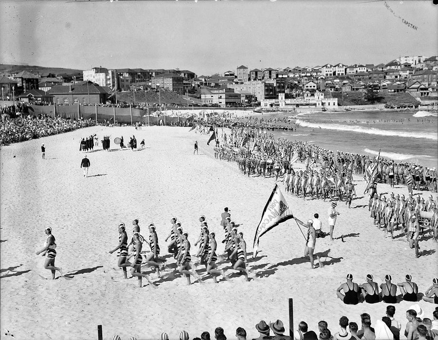 Surf life saving clubs marching past at the Bondi Beach surf carnival — photograph, from Bondi Beach, 1938