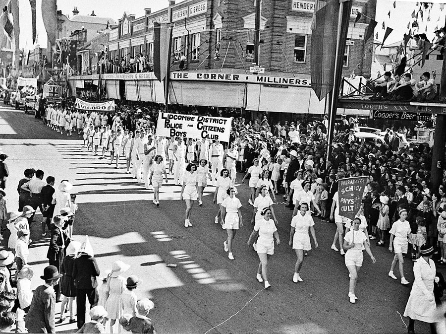 Marching contingents on parade past "The Corner Milliners", Parramatta — photograph, from Parramatta, 1938