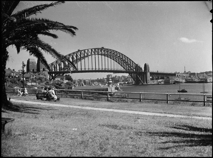 Sydney Harbour Bridge across the water from a foreshore park — photograph, from Sydney Harbour Bridge, Sydney, circa 1950