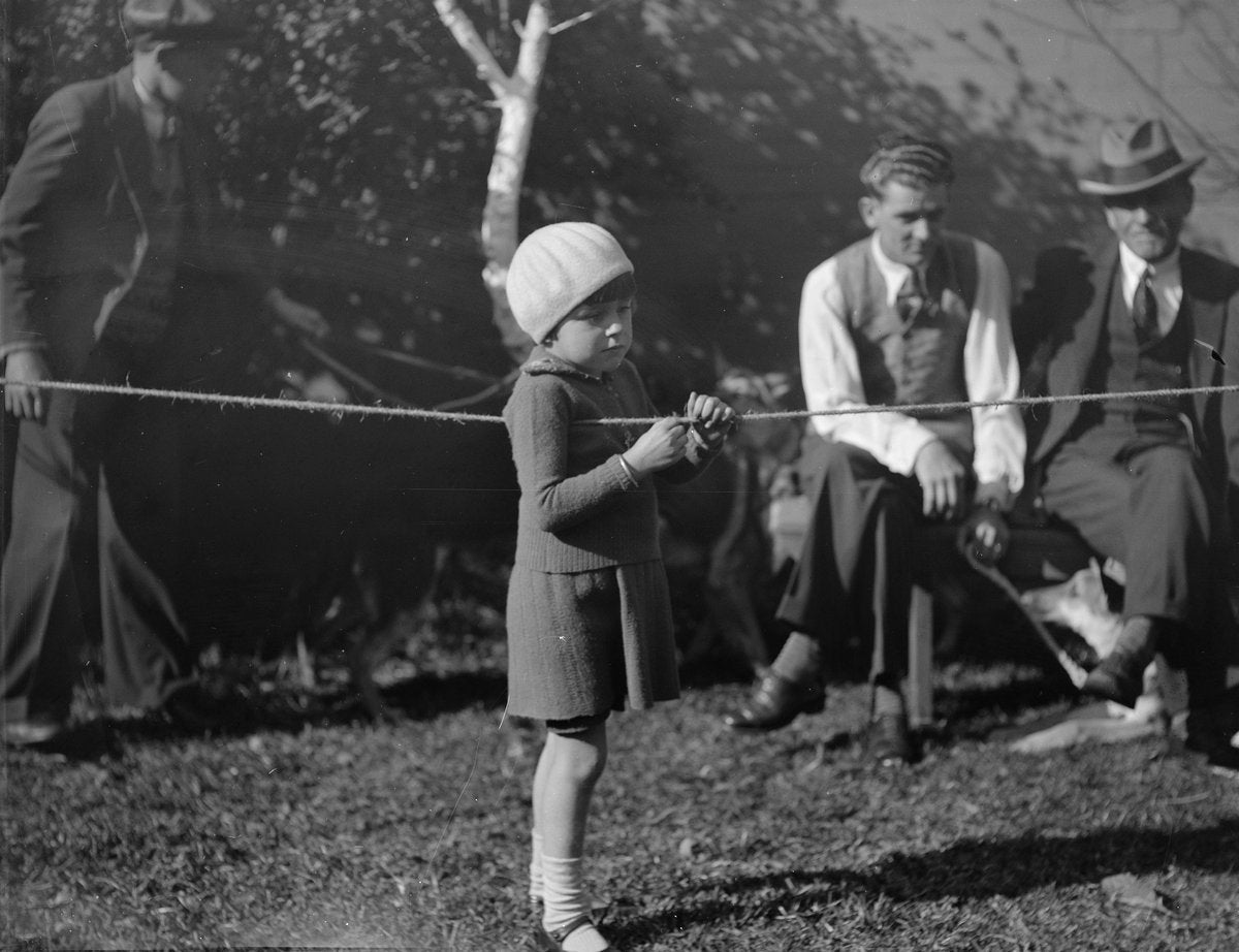 Child at the rope barrier, Erskineville dog show, 1934 — photograph, from Erskineville, circa 1934