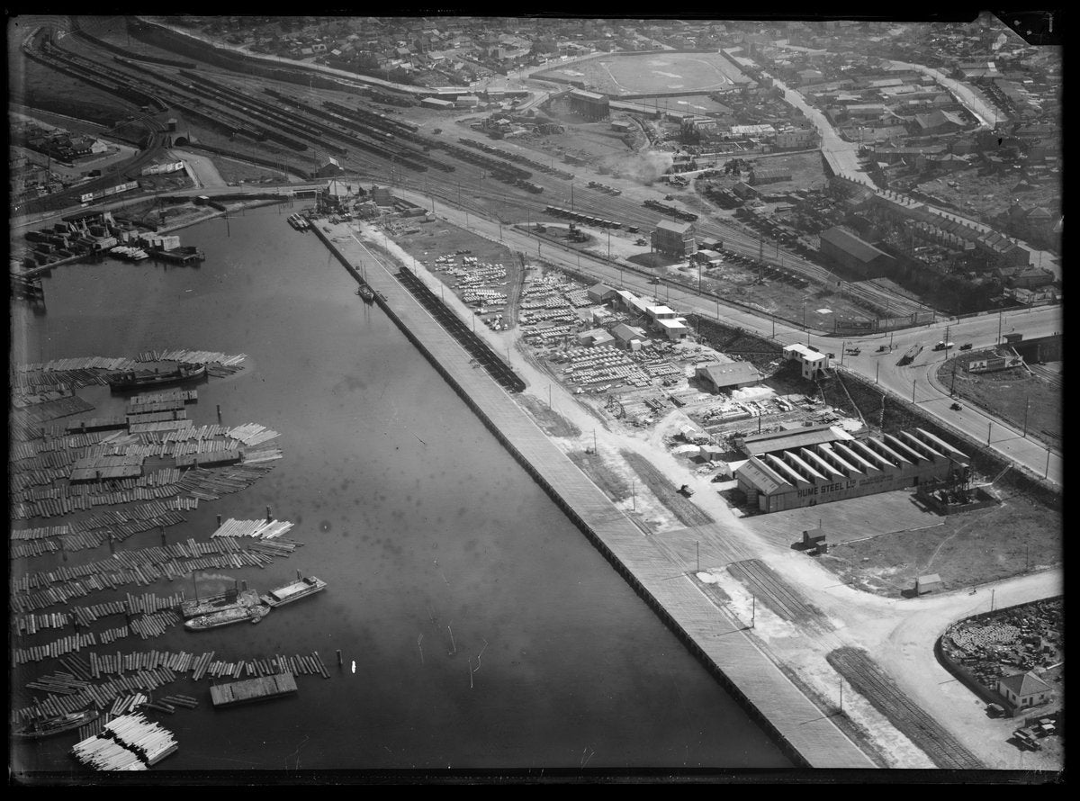 Hume Steel works and timber ponds at Rozelle Bay, aerial view — photograph, from Rozelle Bay, Sydney, circa 1930