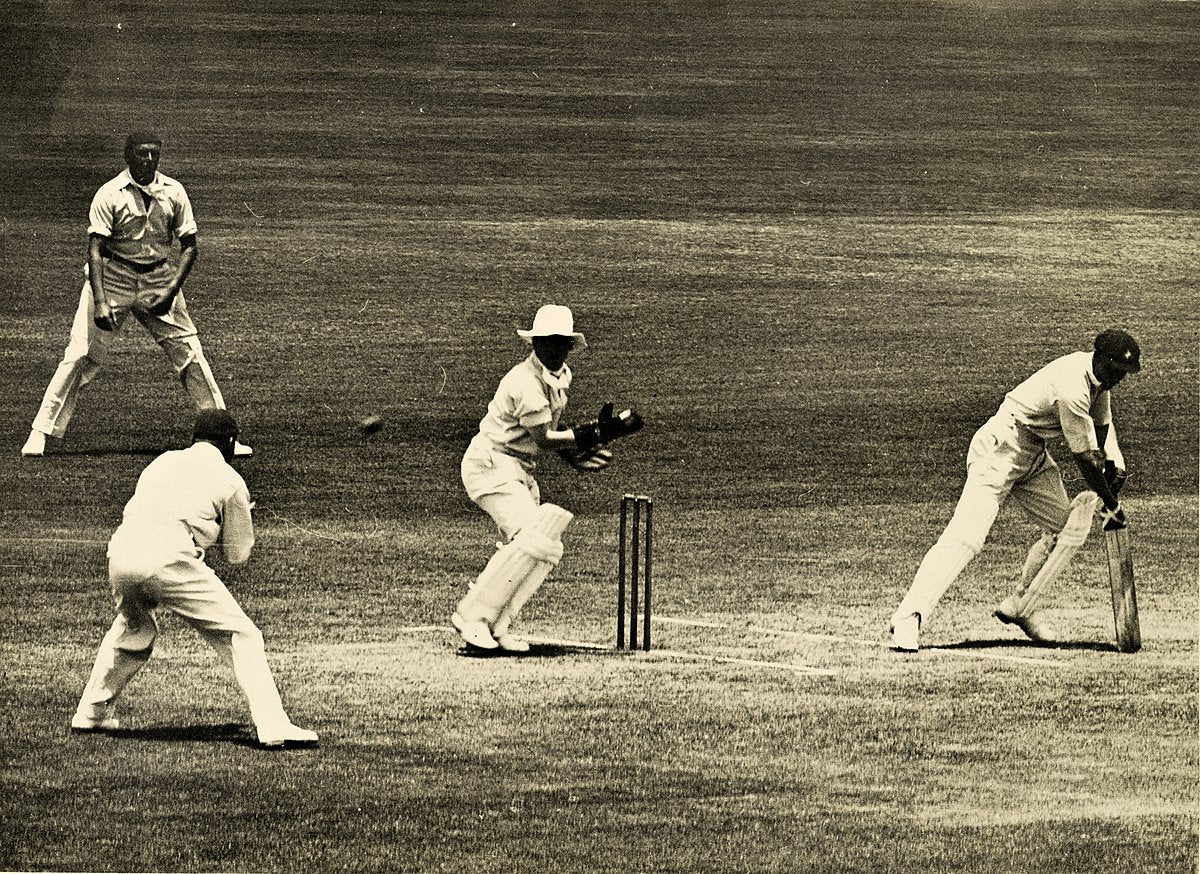Batsman, wicket-keeper and fielders in play during a Sydney cricket match — photograph, from Sydney CBD, circa 1937