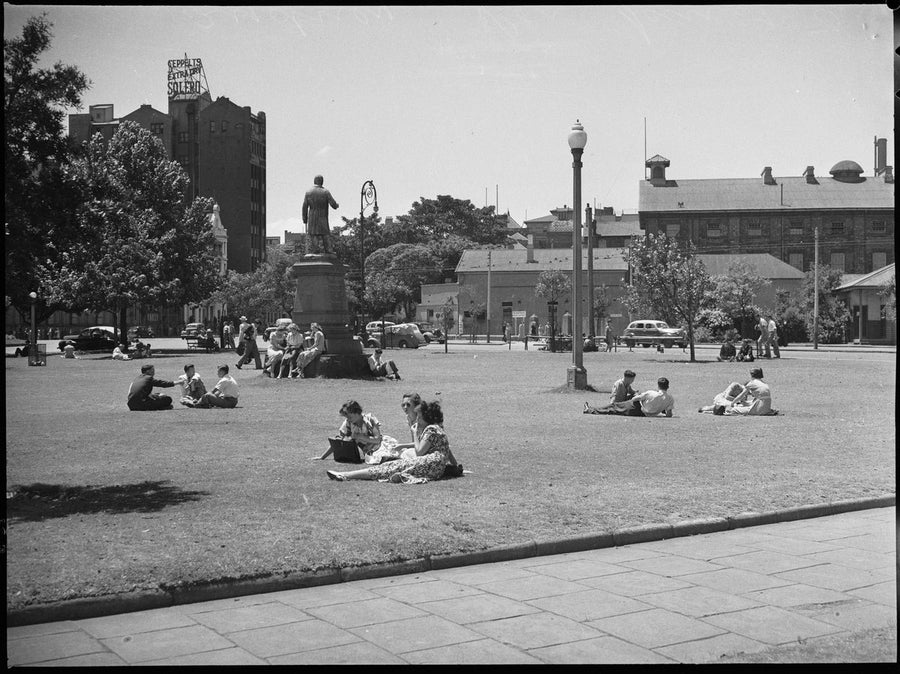 People relaxing on a Sydney park lawn beside a bronze statue, c.1950 — photograph, from Sydney, N.S.W., circa 1950