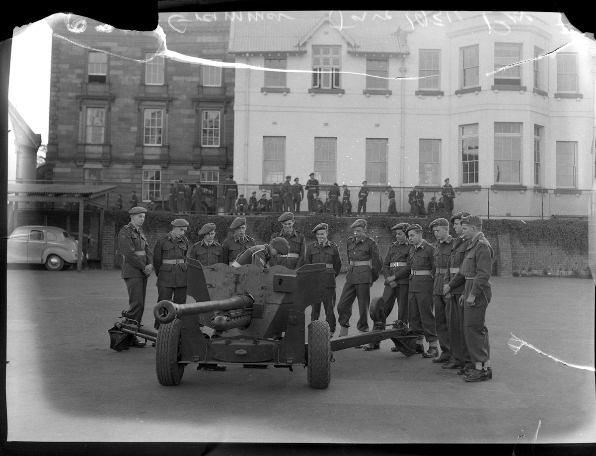 Cadets around a field gun, Sydney Grammar School, 1954 — photograph, from Sydney Grammar School, Darlinghurst, circa 1954