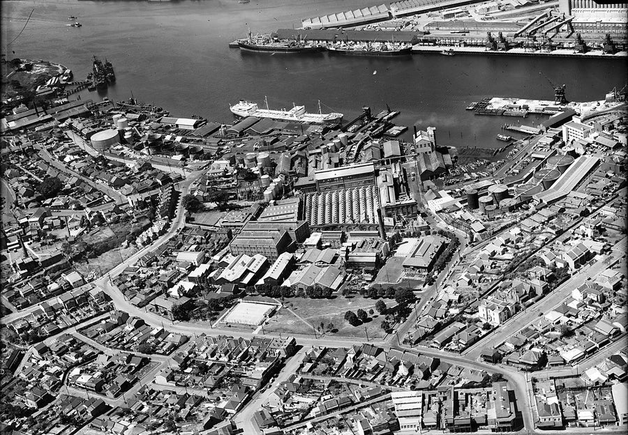 Balmain waterfront and Ampol installation from the air — photograph, from Balmain, c. 1950