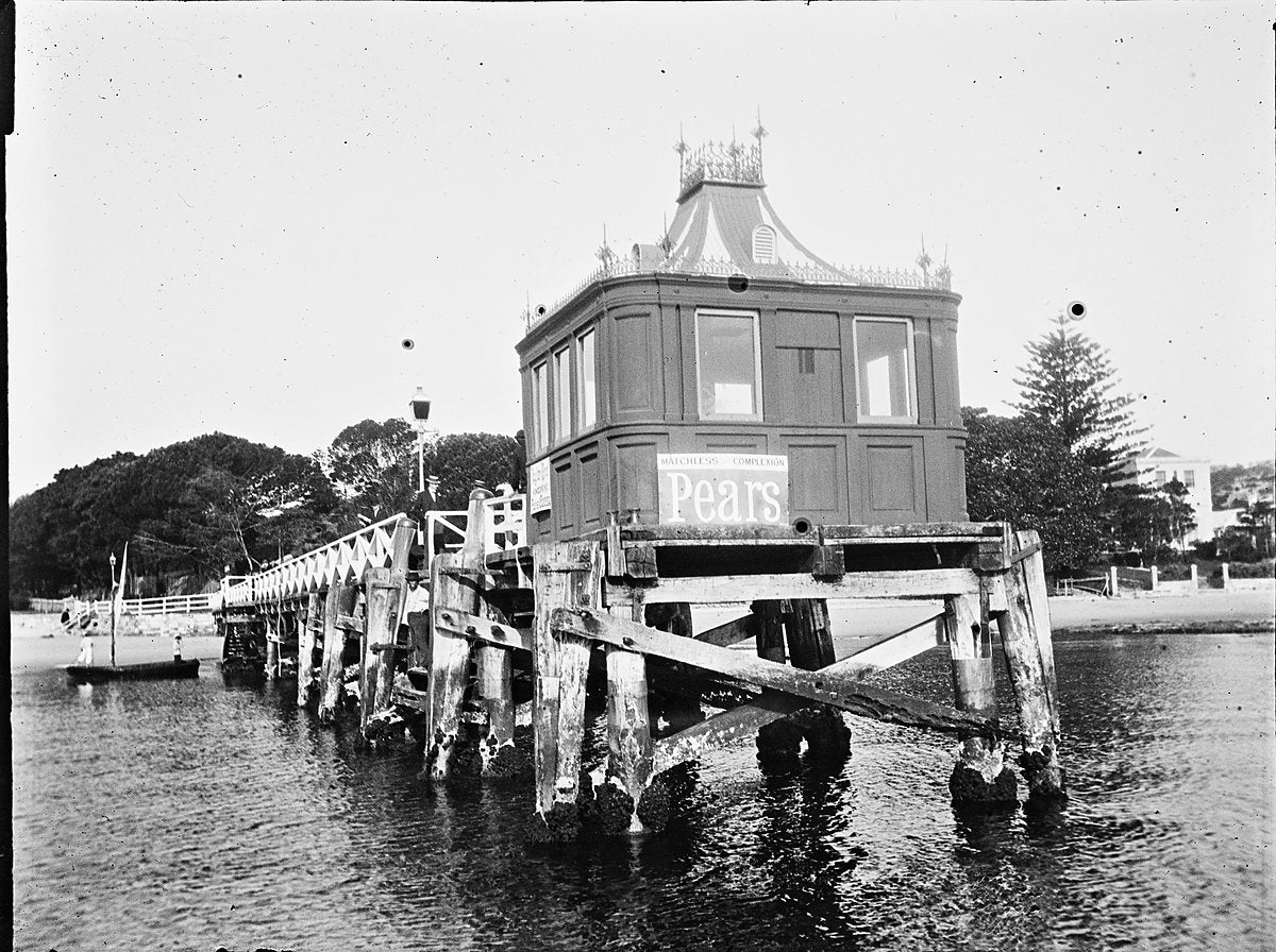 Timber jetty and pavilion at Manly Wharf, with Pears advert — photograph, from Manly Wharf, circa 1900