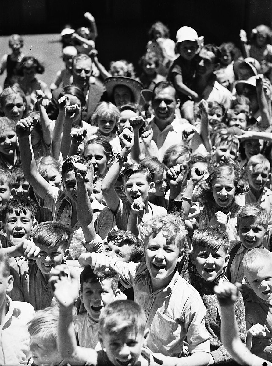 Schoolchildren cheering, Paddington school playground, 1940 — photograph, from Paddington, circa 1940