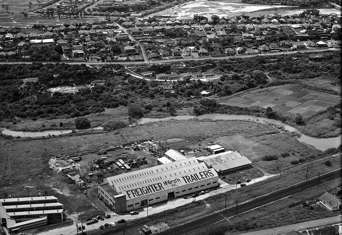 Freighter McGrath Trailers works, aerial view — photograph, from Turrella, c. 1950