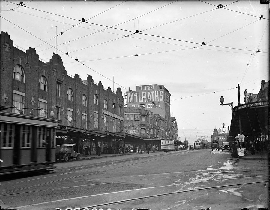 Trams beneath the McIlrath's grocery sign, Sydney — photograph, circa 1934