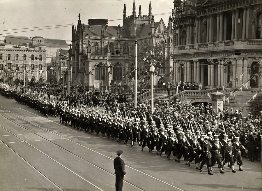 Servicemen marching past St Andrew's Cathedral and Sydney Town Hall, Sydney — photograph, from Sydney Town Hall, circa 1938