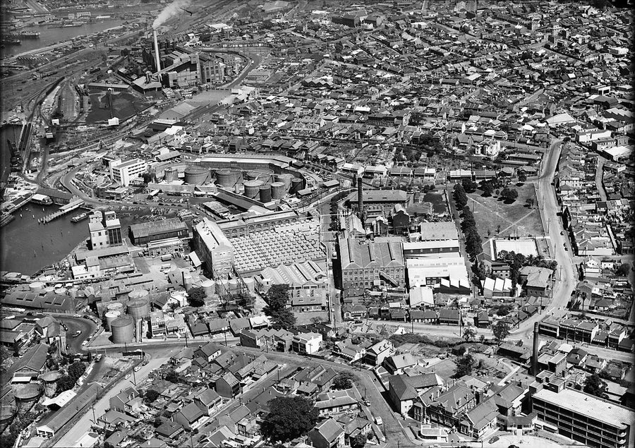 Ampol's Balmain terminal and harbour foreshore from the air — photograph, from Balmain, c. 1950