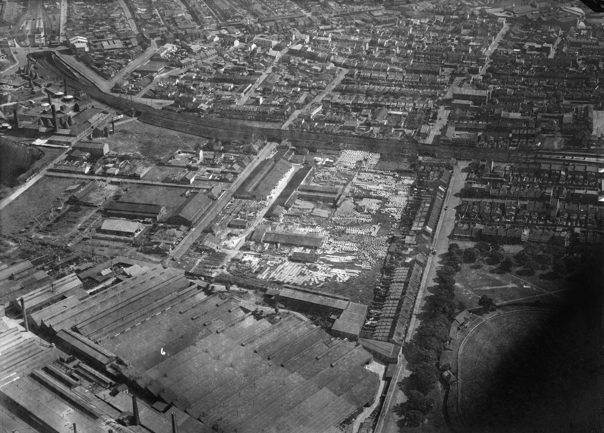 Aerial view over an Alexandria industrial precinct with pipe yards and terraced housing — photograph, from Alexandria, circa 1930