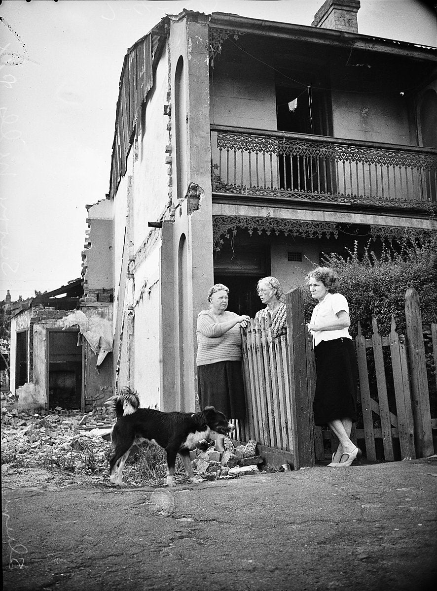 Three women outside a terrace house during demolitions, Surry Hills, 1950 — photograph, from Surry Hills, circa 1950
