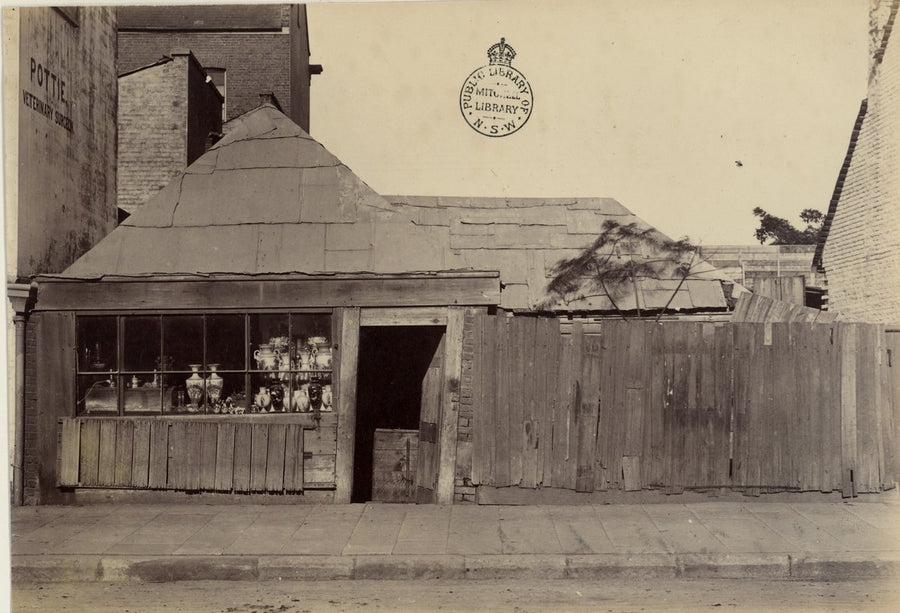 Pottie's shopfront and condemned timber buildings, Castlereagh Street, Sydney — photograph, from Castlereagh Street, Sydney, circa 1880