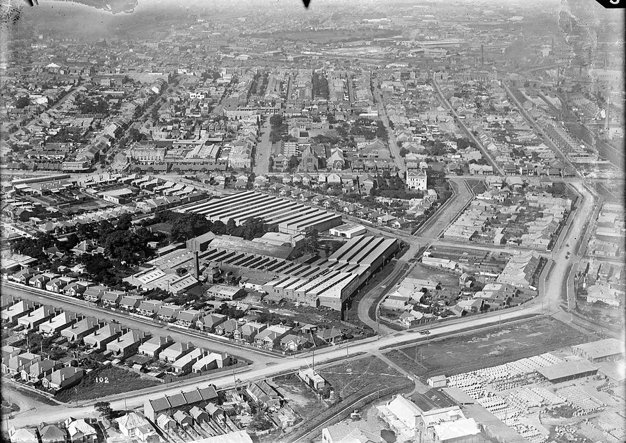 Sawtooth-roofed factory ranges among terraced streets, Sydney — photograph, c. 1937