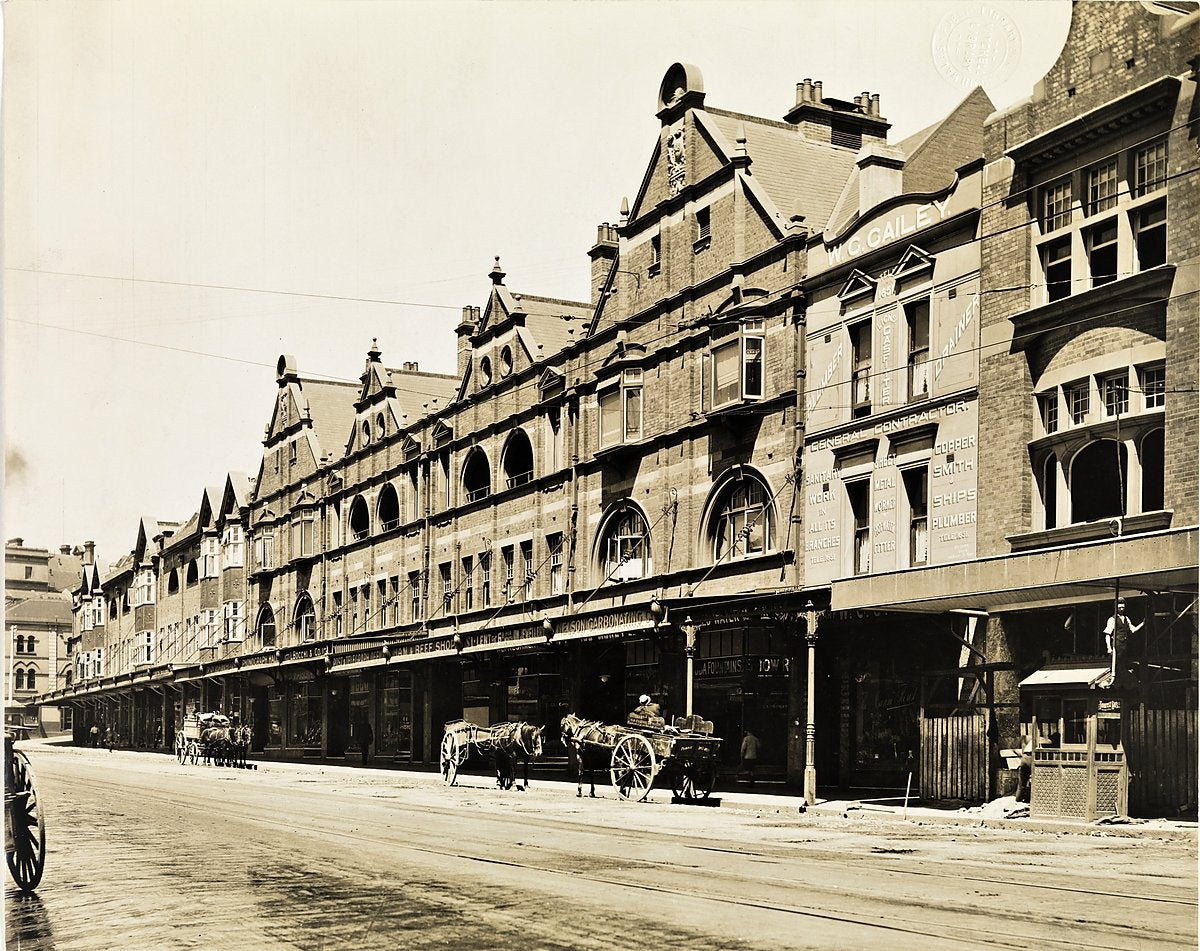 Gabled shopfront terrace and horse-drawn carts, Sydney — photograph, from Sydney, circa 1909