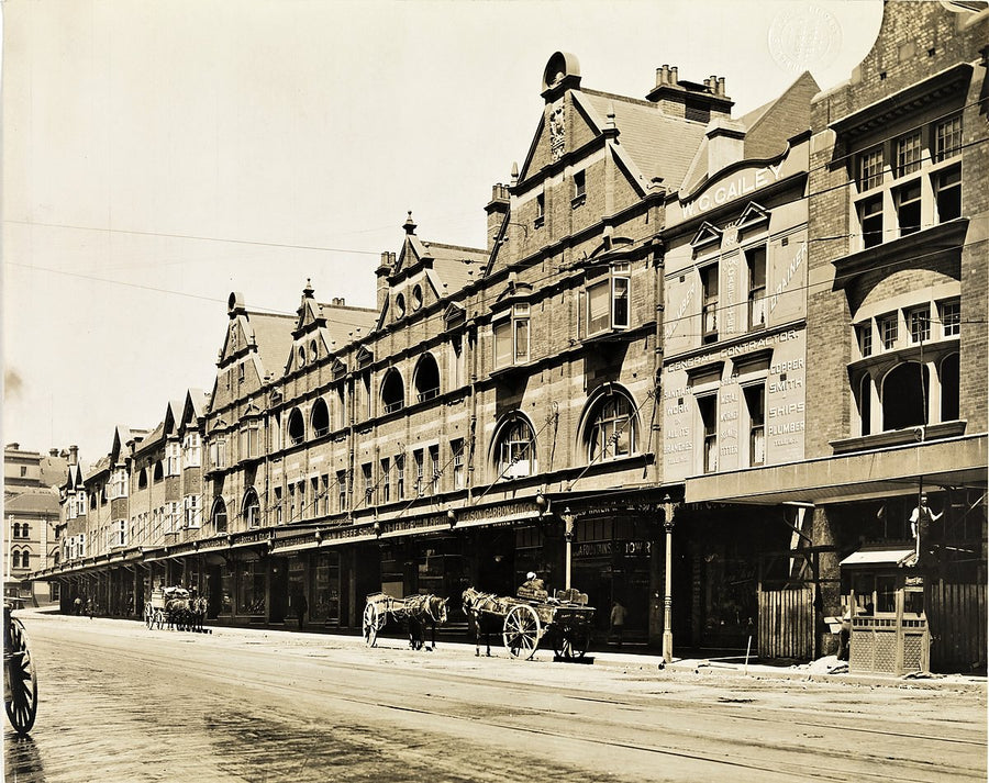 Gabled shopfront terrace and horse-drawn carts, Sydney — photograph, from Sydney, circa 1909