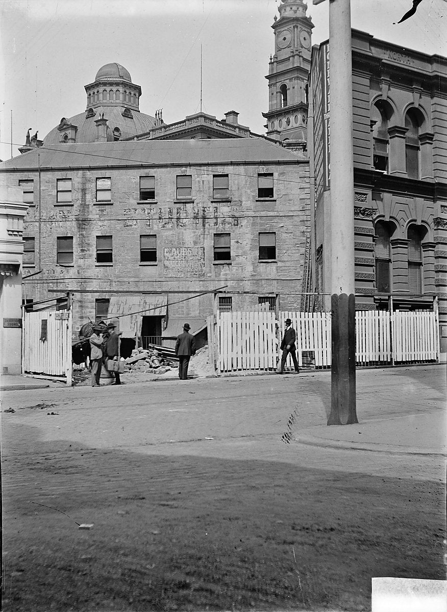 Auction rooms and a street hoarding, Sydney — photograph, circa 1900