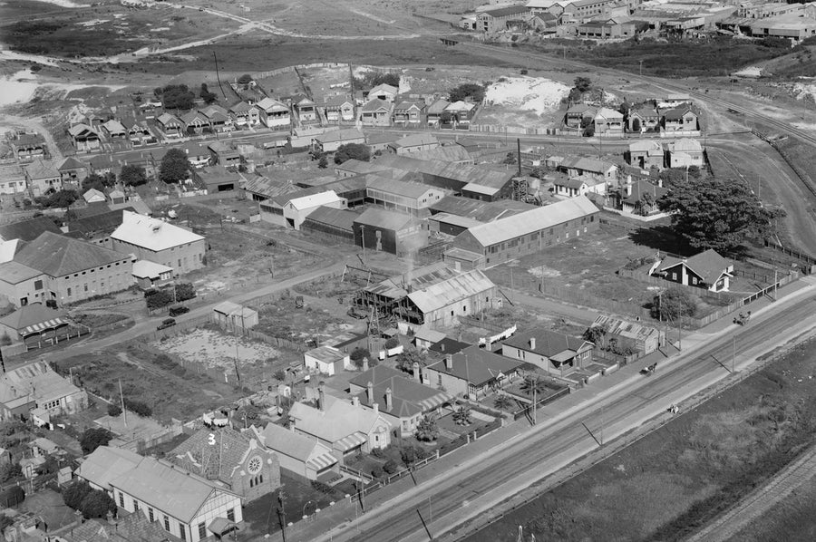 Norton Bros Ltd works among suburban streets and a rail line, from the air — photograph, circa 1930
