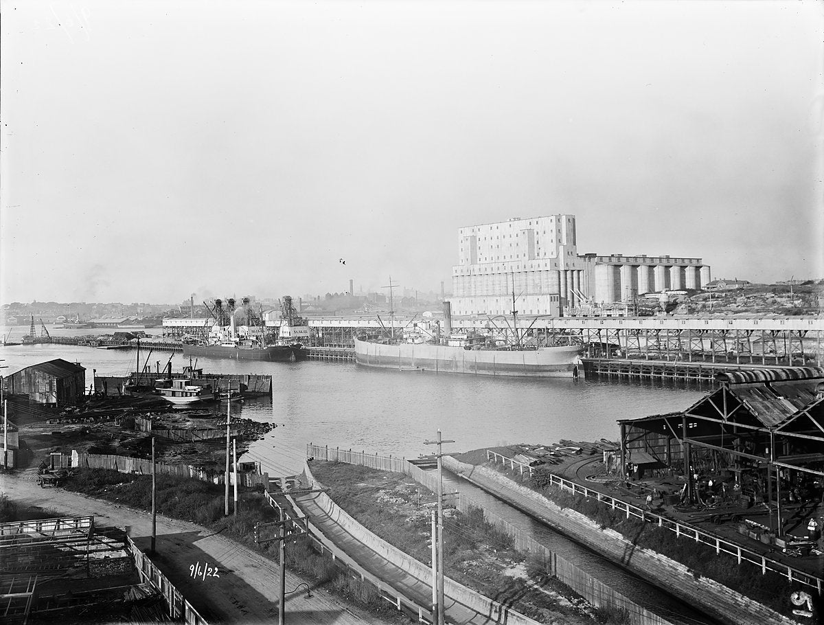 Glebe Island wheat silos and wharves, 1922 — photograph, from Rozelle, circa 1922