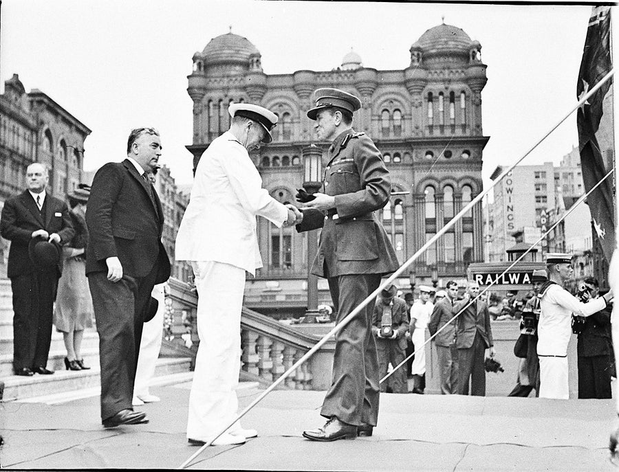 Officers greet on a parade platform before the Queen Victoria Building — photograph, from George Street, circa 1940