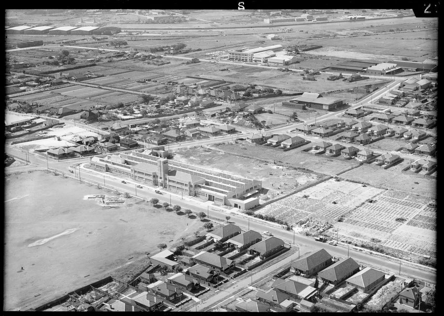 Multi-storey factory among market gardens and housing, Mascot — photograph, from Mascot, circa 1940