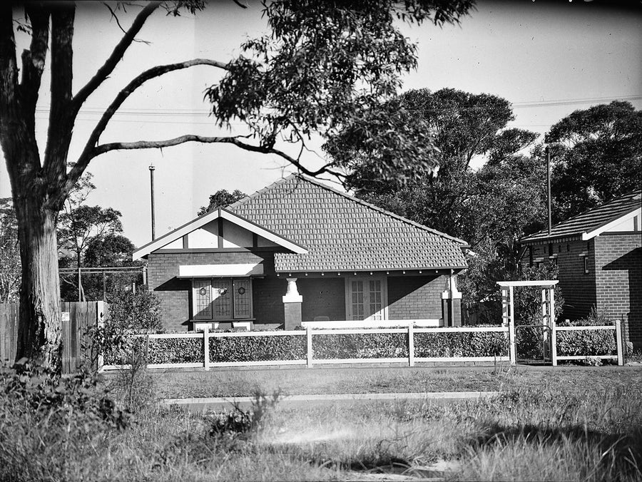 Tiled-roof brick bungalow on an unidentified suburban street — photograph, circa 1938