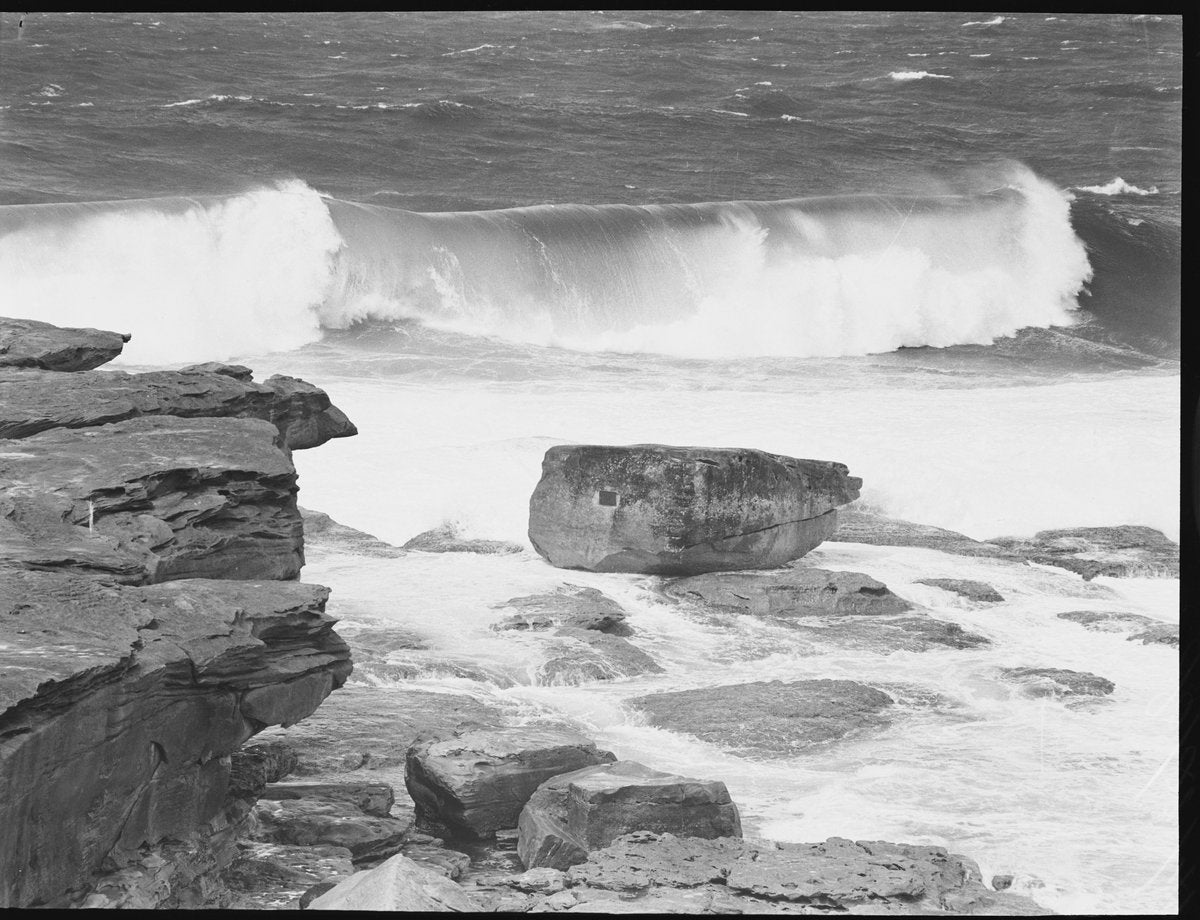 Heavy surf breaking over a sandstone rock platform, 1940 — photograph, circa 1940