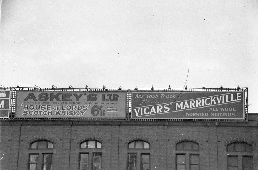 Sky-signs on Central Station Building: Askey's Scotch Whisky and Vicars' Marrickville — photograph, from Eddy Avenue, circa 1930