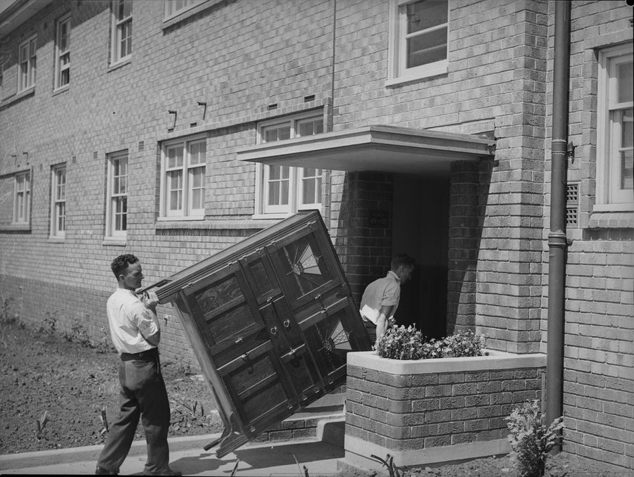 Carrying a sideboard into new flats at Erskineville, 1938 — photograph, from Erskineville, circa 1938