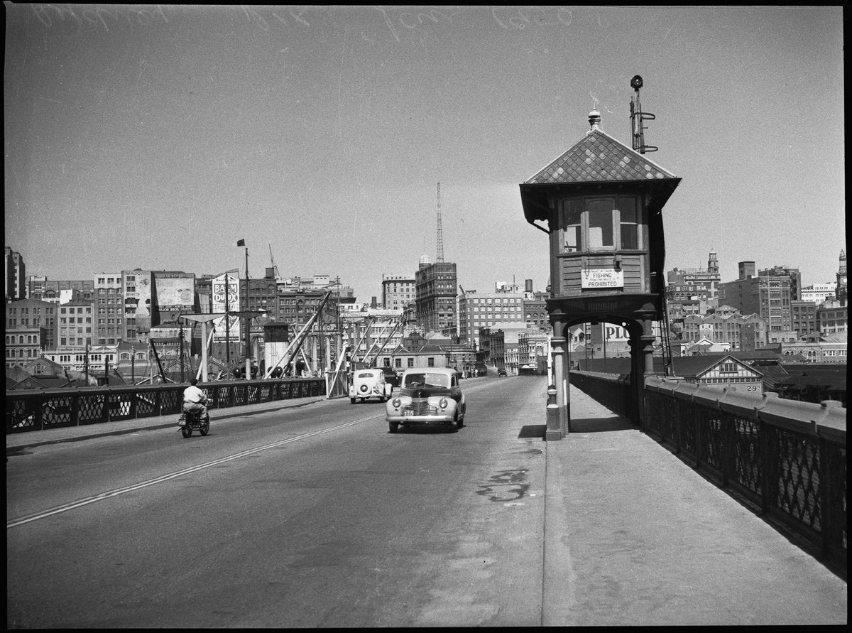 Watch house on Pyrmont Bridge, with the city skyline beyond — photograph, from Pyrmont Bridge, Darling Harbour, Sydney, circa 1950