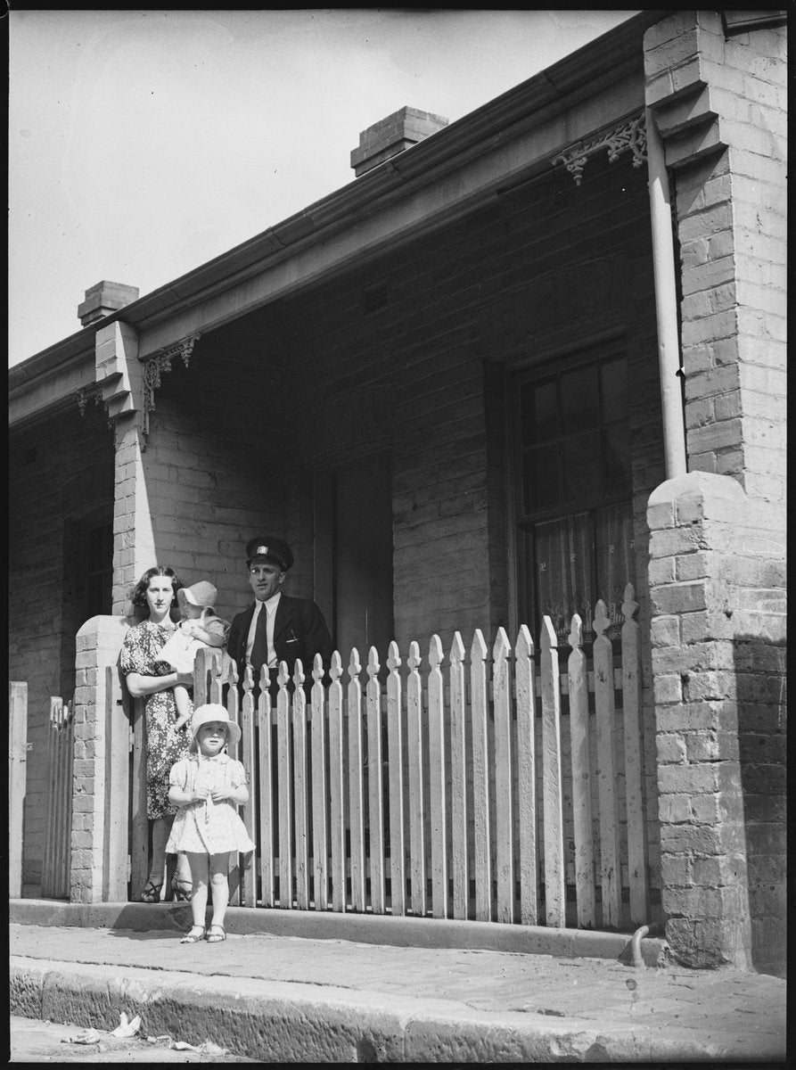 Family at the picket fence of an Erskineville cottage, 1938 — photograph, from Erskineville, circa 1938